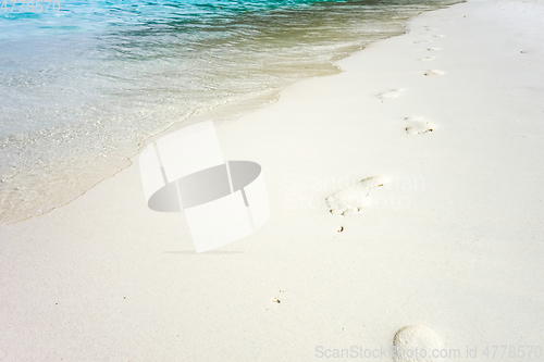 Image of footprints on a tropical beach