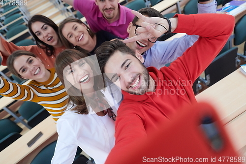 Image of Group of multiethnic teenagers taking a selfie in school