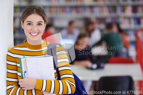 Image of the student uses a notebook and a school library