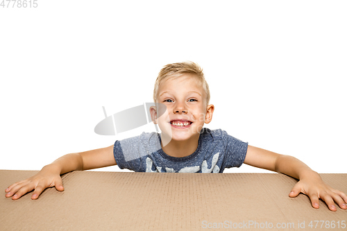 Image of Cute little boy opening the biggest postal package