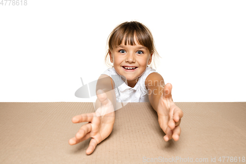 Image of Cute little girl opening the biggest postal package