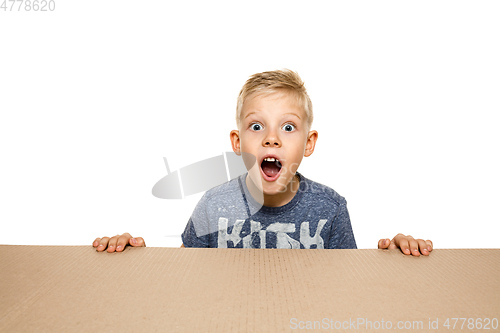 Image of Cute little boy opening the biggest postal package