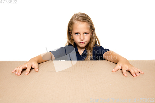 Image of Cute little girl opening the biggest postal package