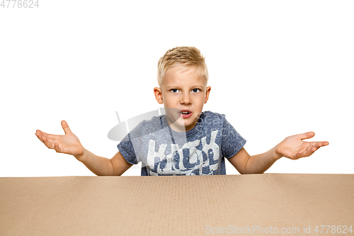 Image of Cute little boy opening the biggest postal package