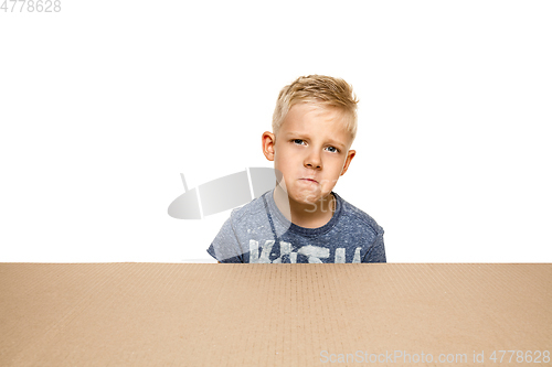 Image of Cute little boy opening the biggest postal package