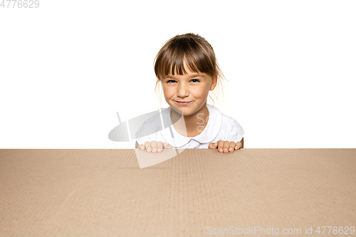 Image of Cute little girl opening the biggest postal package
