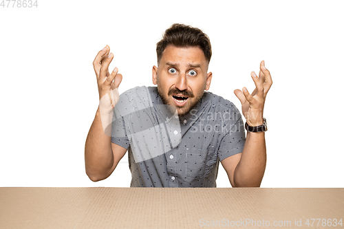 Image of Shocked man opening the biggest postal package