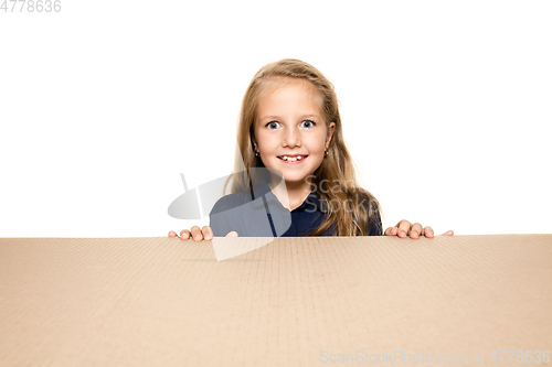 Image of Cute little girl opening the biggest postal package