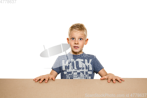 Image of Cute little boy opening the biggest postal package