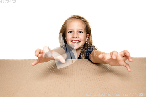 Image of Cute little girl opening the biggest postal package