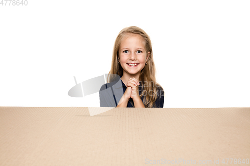 Image of Cute little girl opening the biggest postal package