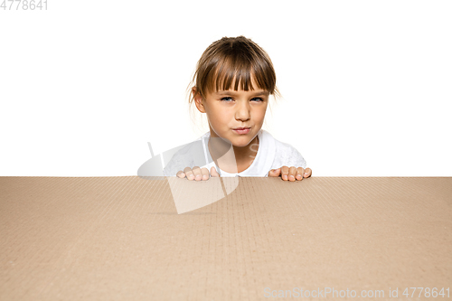 Image of Cute little girl opening the biggest postal package