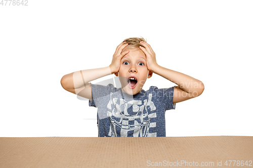 Image of Cute little boy opening the biggest postal package