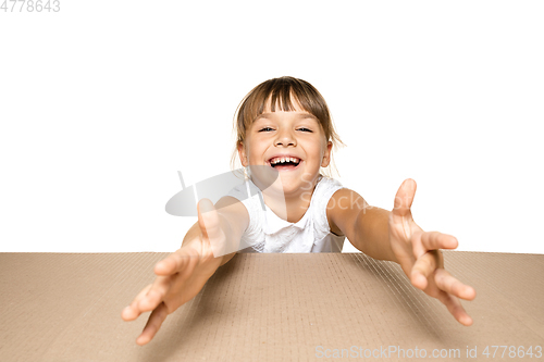 Image of Cute little girl opening the biggest postal package