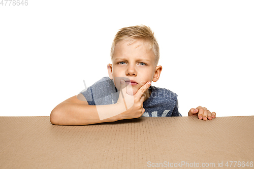 Image of Cute little boy opening the biggest postal package