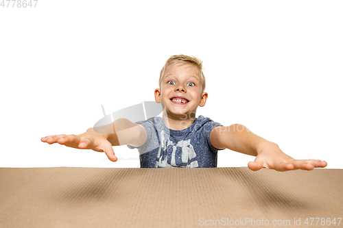 Image of Cute little boy opening the biggest postal package