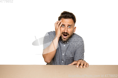 Image of Shocked and upset man opening the biggest postal package