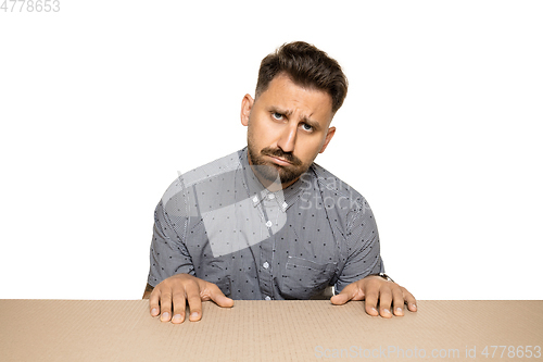 Image of Shocked and upset man opening the biggest postal package