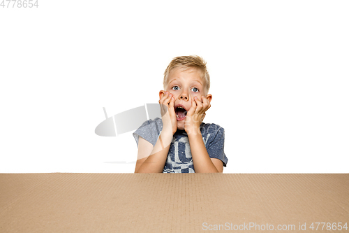 Image of Cute little boy opening the biggest postal package