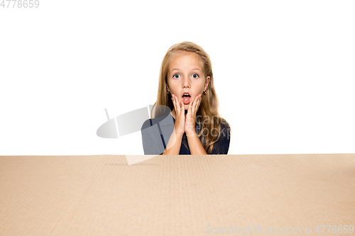 Image of Cute little girl opening the biggest postal package