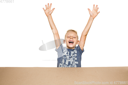 Image of Cute little boy opening the biggest postal package