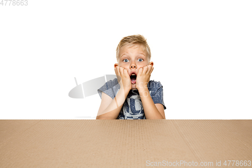 Image of Cute little boy opening the biggest postal package