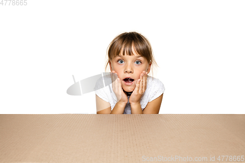 Image of Cute little girl opening the biggest postal package