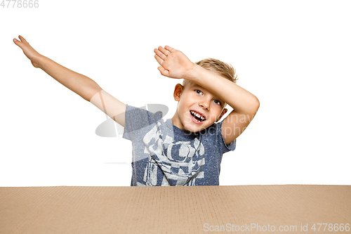 Image of Cute little boy opening the biggest postal package