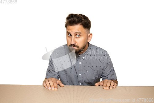 Image of Shocked and upset man opening the biggest postal package