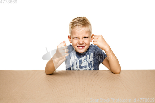 Image of Cute little boy opening the biggest postal package
