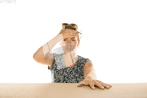 Image of Young woman opening the biggest postal package isolated on white