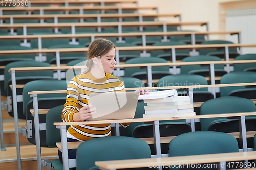 Image of student taking notes for school class