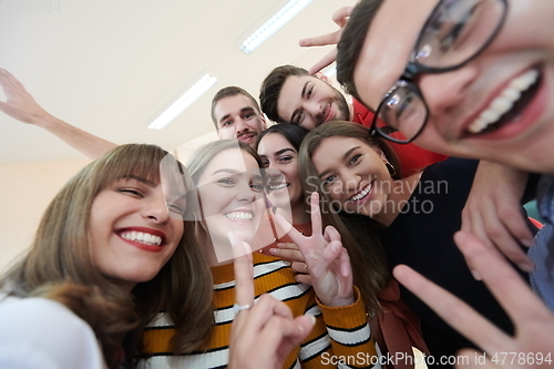 Image of Group of multiethnic teenagers taking a selfie in school