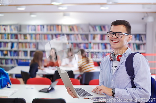 Image of the student uses a notebook, latop and a school library