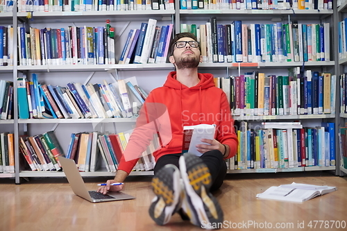 Image of the students uses a notebook, laptop and a school library