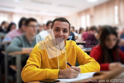 Image of student taking notes while studying in high school