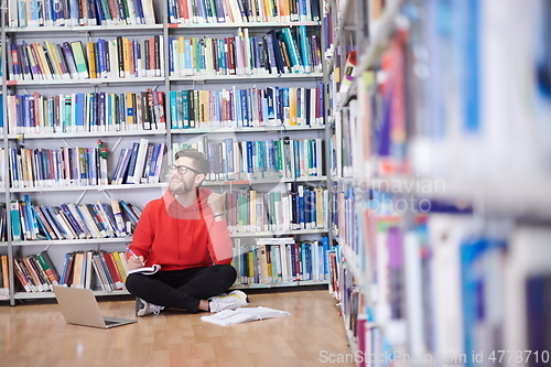 Image of the students uses a notebook, laptop and a school library