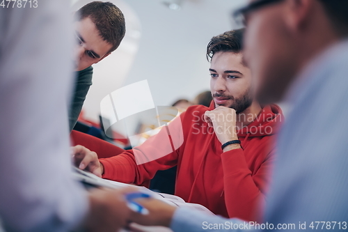 Image of students group working on school project together on tablet computer at modern university