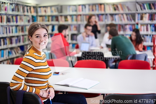 Image of student taking notes for school class