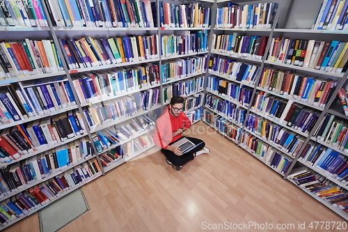 Image of the students uses a notebook, laptop and a school library