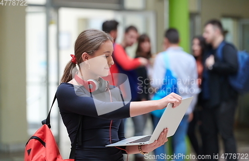 Image of famel student with modern technology in school