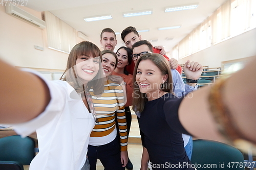 Image of Group of multiethnic teenagers taking a selfie in school