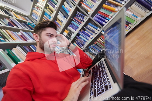 Image of the students uses a notebook, laptop and a school library