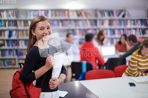 Image of the student uses a notebook and a school library