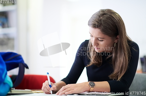 Image of student taking notes for school class