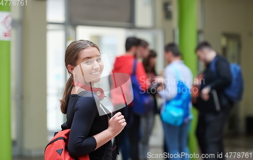 Image of famel student with modern technology in school