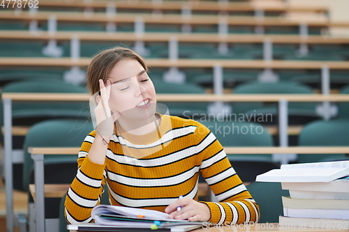Image of student taking notes for school class