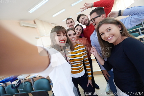 Image of Group of multiethnic teenagers taking a selfie in school