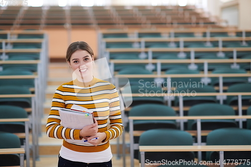 Image of famale student using pen and notebook