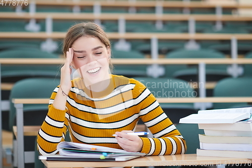 Image of student taking notes for school class